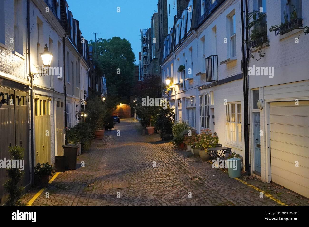 Cobblestoned alley with mews houses in Kensington area of London, England Stock Photo