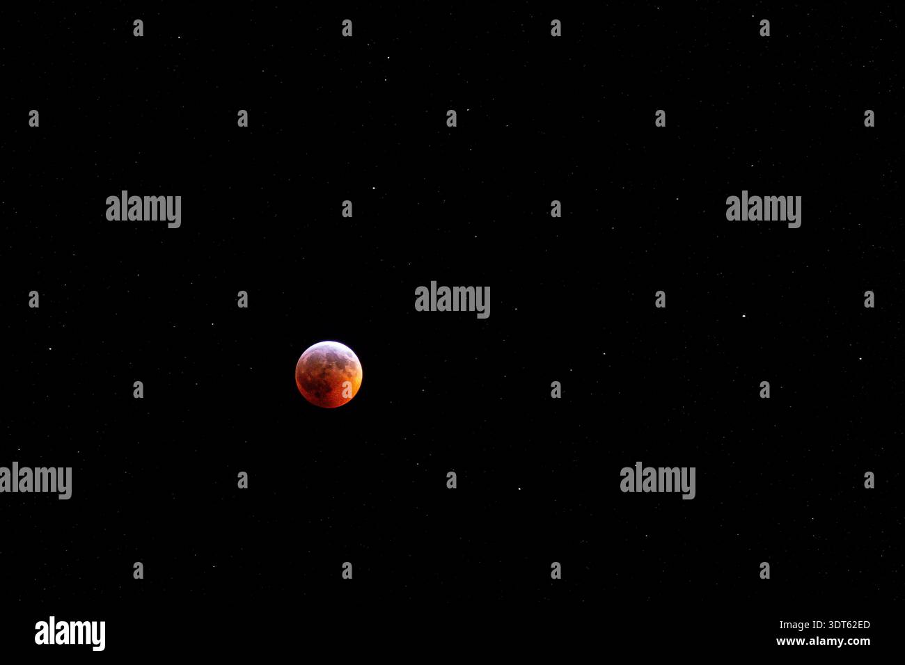 Total lunar eclipse blood moon with stars in night sky Stock Photo - Alamy