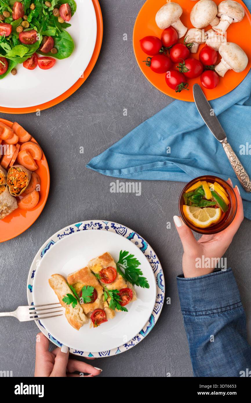 Colorful Salad and Meal Selection With Drinks on a Table in a Cozy Setting Stock Photo