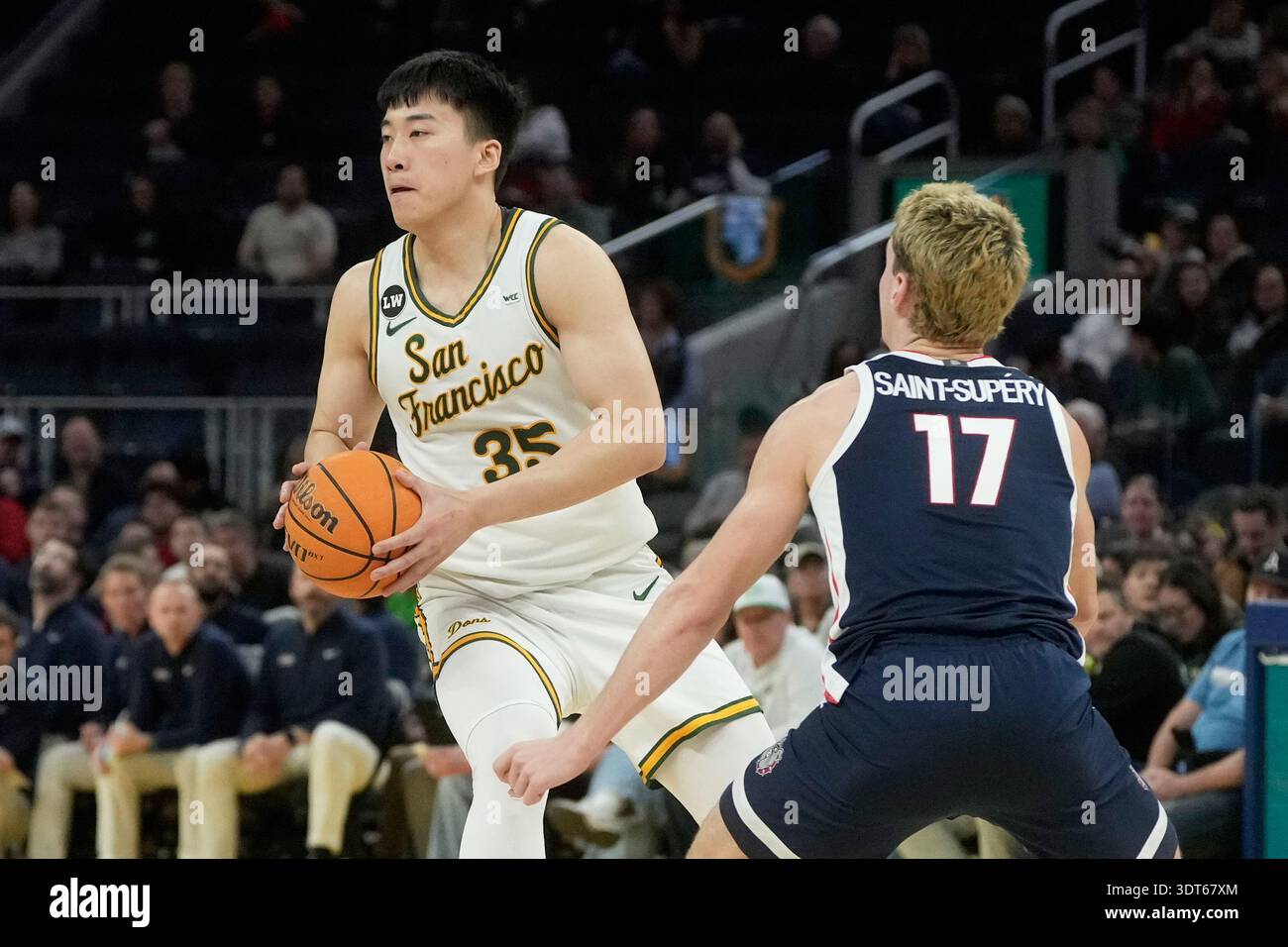 San Francisco forward Junjie Wang (35) looks to pass while being ...