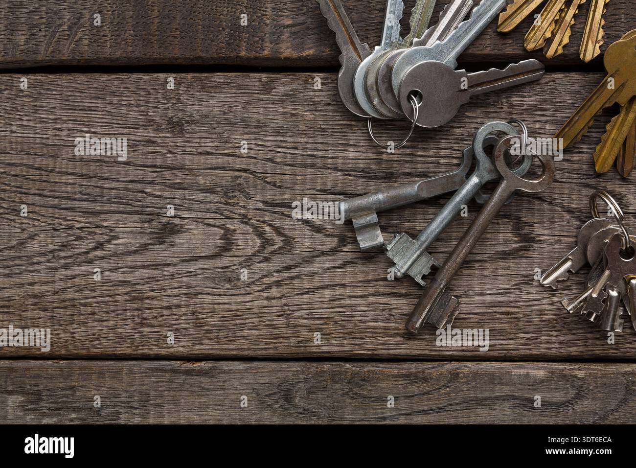 Collection of Old Keys Arranged on a Wooden Surface Stock Photo
