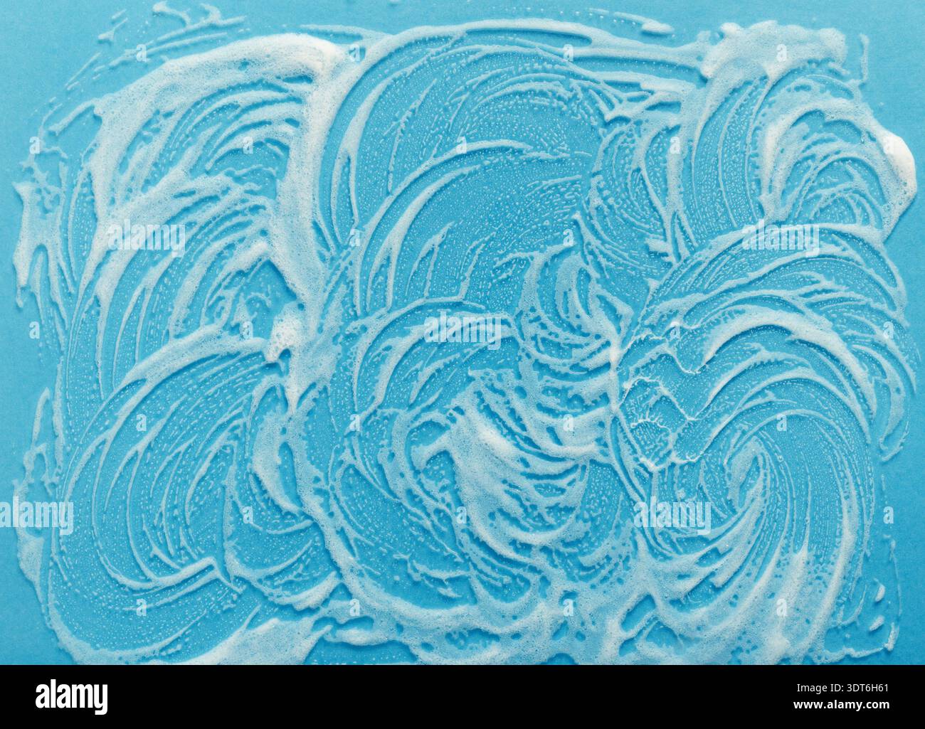 Collection of Soap Bubbles Creating a Unique Pattern on a Blue Background Surface Stock Photo
