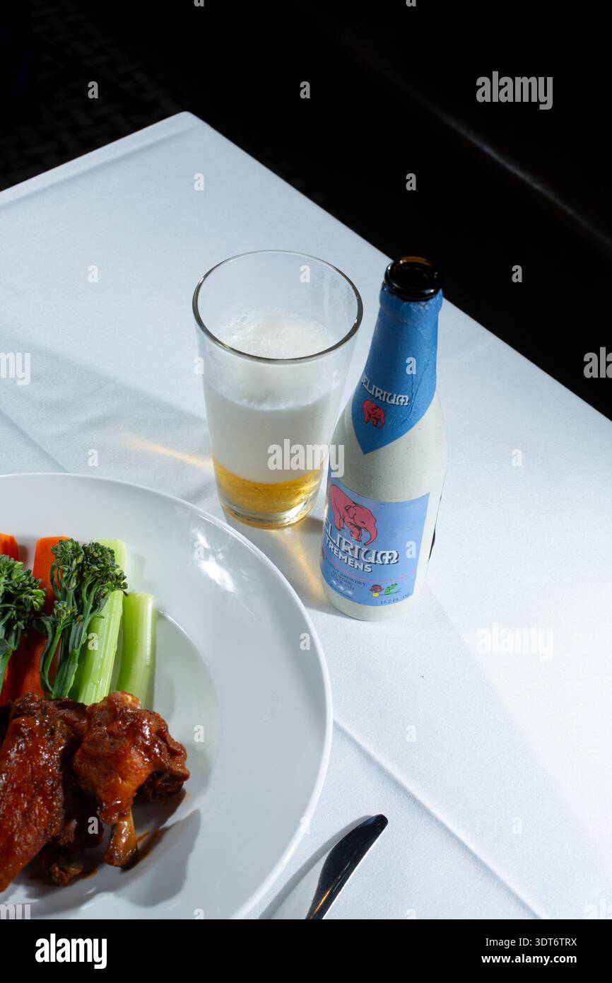 Los Angeles, California, United States - 09-30-2023: A view of a bottle of Delirium Tremens beer next to glass that is half full. Stock Photo