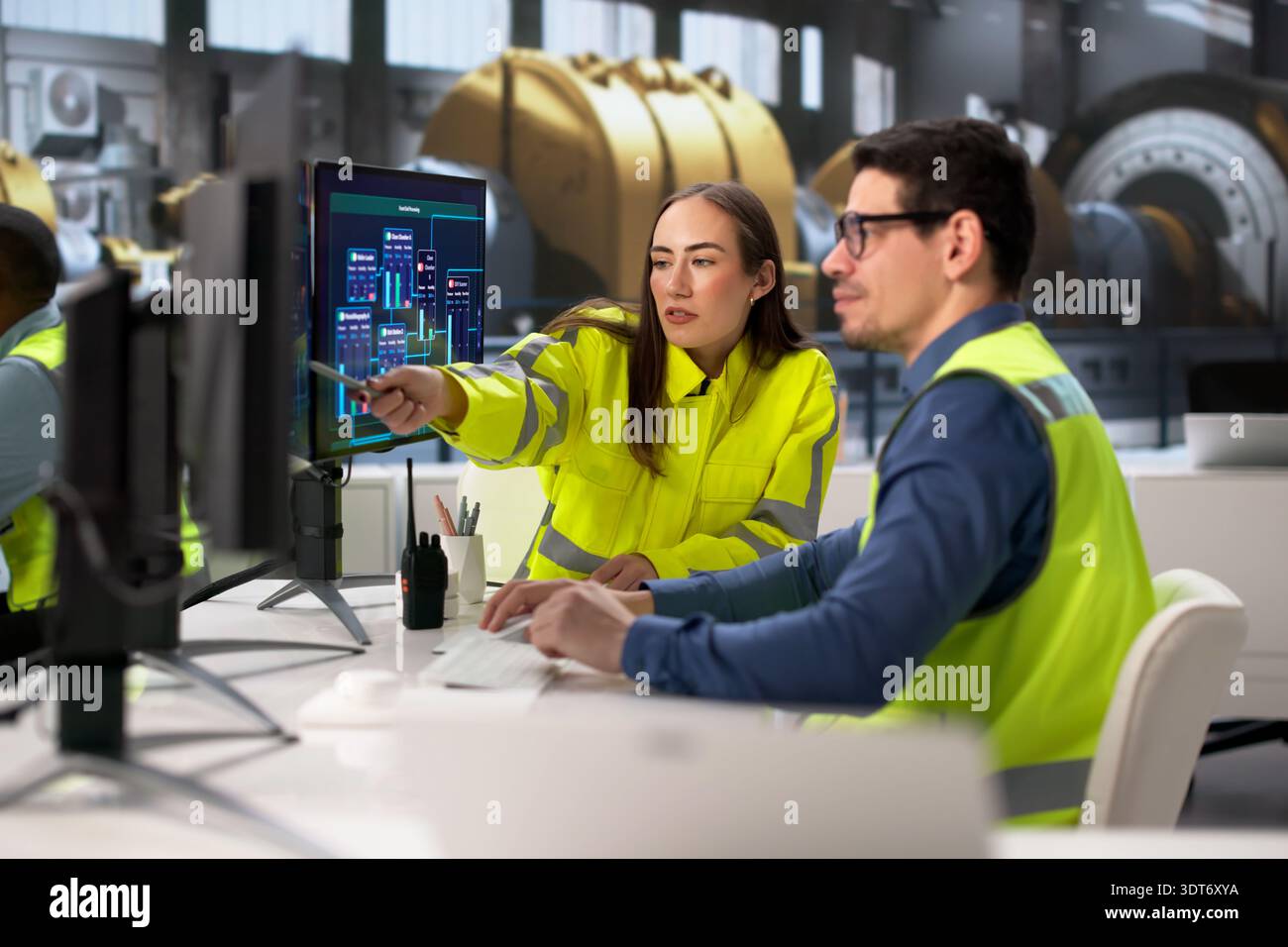 Engineers Operating Multiple Screens At Power Plant In Desktop Computer Stock Photo