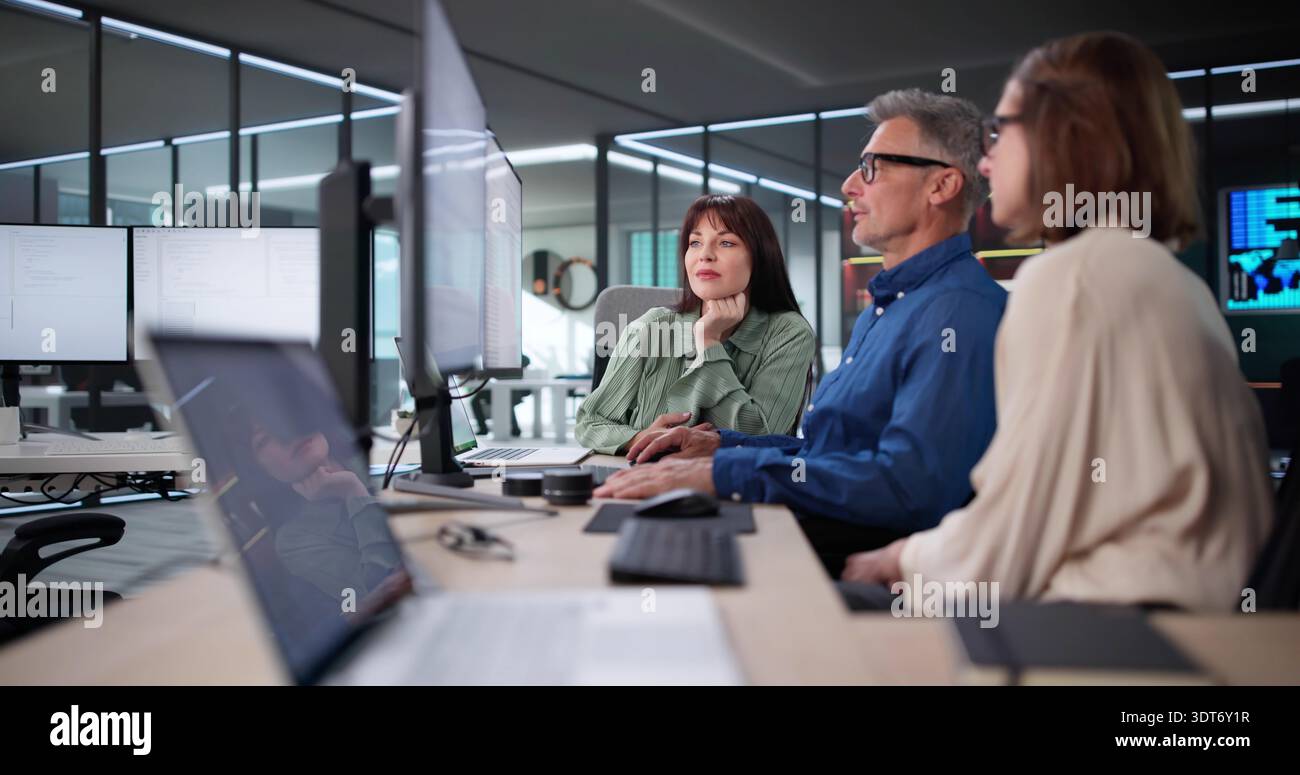 Woman programming on multiple monitors hi-res stock photography and ...