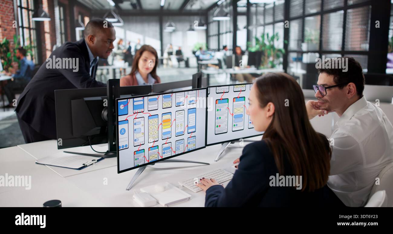 Diverse Team Of Young Professionals Developing Websites On Computer Screens. Stock Photo