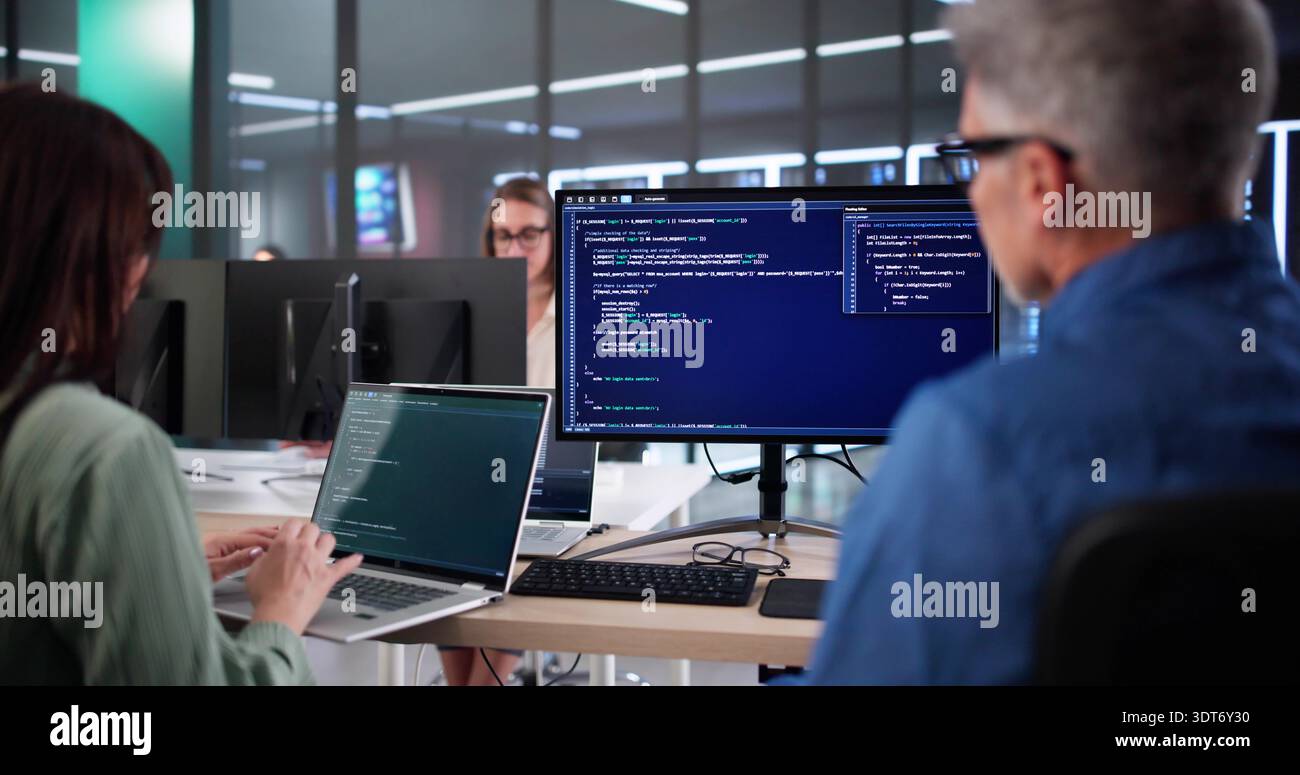 Senior Developers Coaching AI Team In Secure Business Code Office. Stock Photo