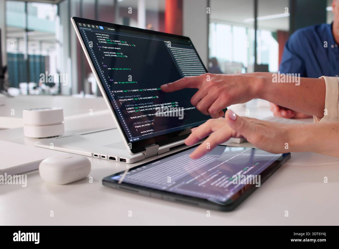Female Programmer Creating Software Application With Team In Office Setting Stock Photo