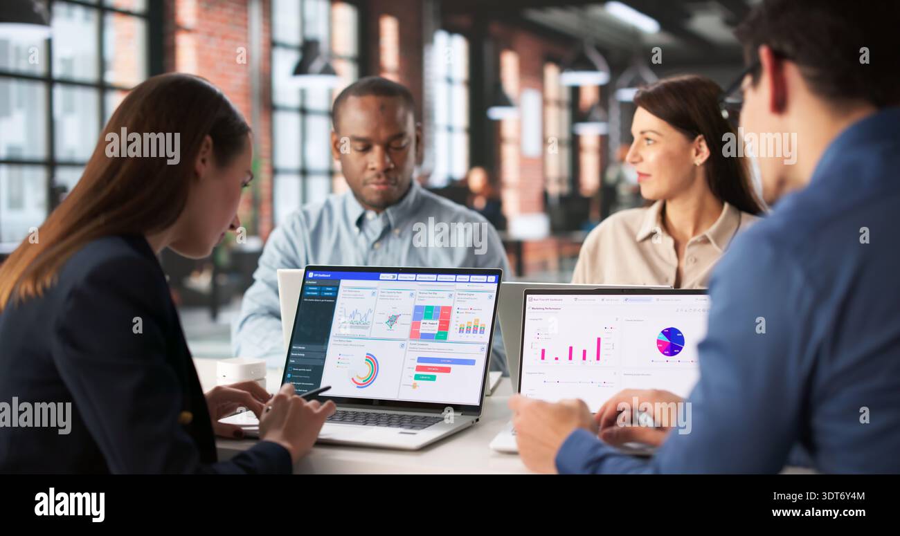 Analyzing Financial Reports On Personalized Data Analytics Dashboard During Team Meeting. Stock Photo