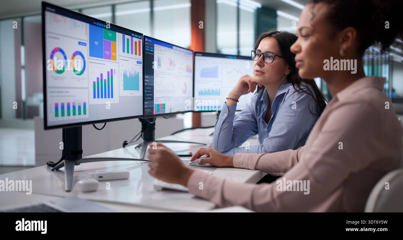 Diverse Women On Analytics Team Analyzing Financial Data At Office. Stock Photo