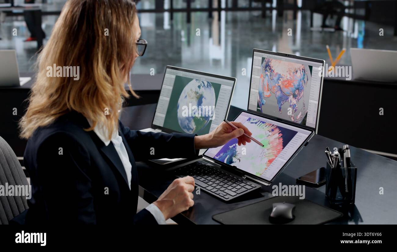 Professional Woman Forecasting Weather Patterns On Computer At Meteorology Office. Stock Photo