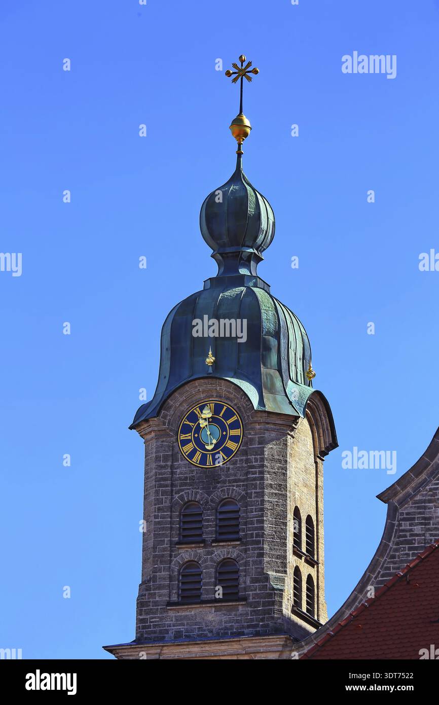 The green church tower of the Holy Cross Church rises with clock and ...