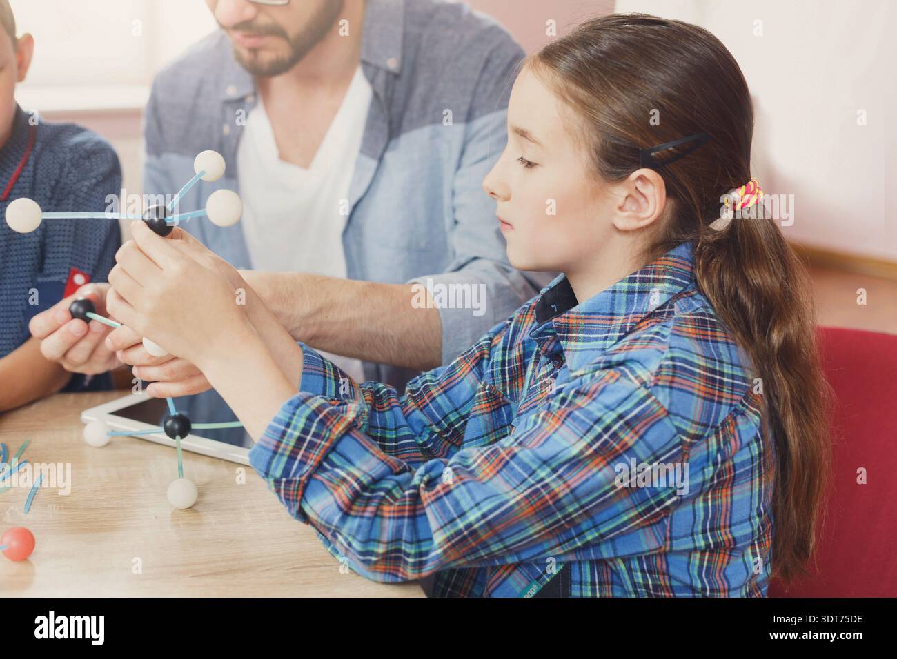 Students Learn About Molecules Through Hands-On Activities in Classroom Stock Photo