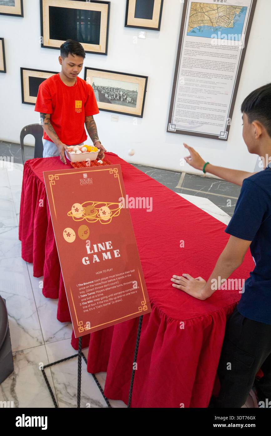 Visitors playing traditional Chinese line game activity inside Cebu ...