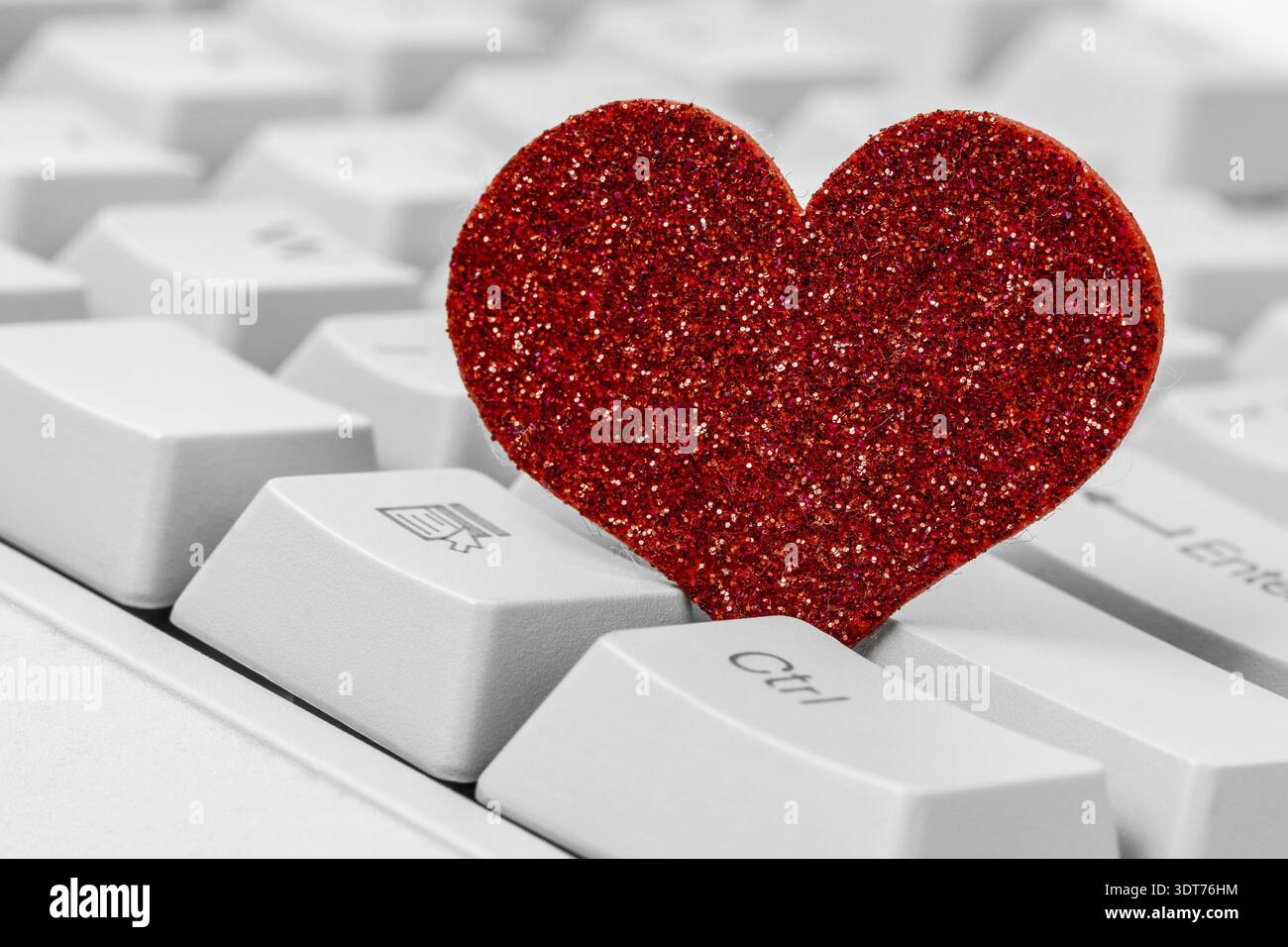 Single red heart on computer keyboard. Internet dating concept Stock Photo