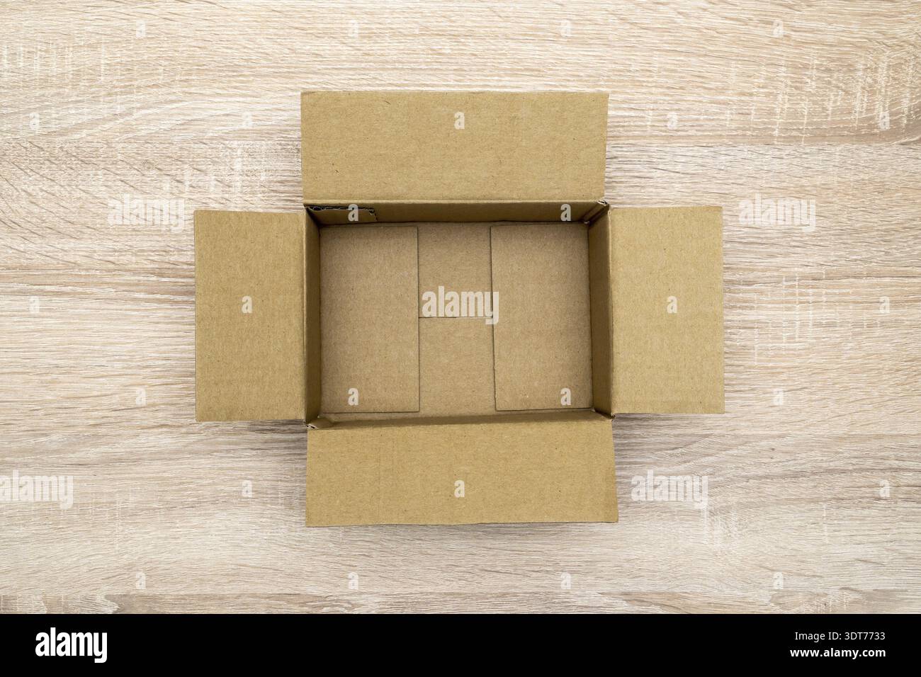Empty open rectangular cardboard box on the wooden table. Top view Stock Photo