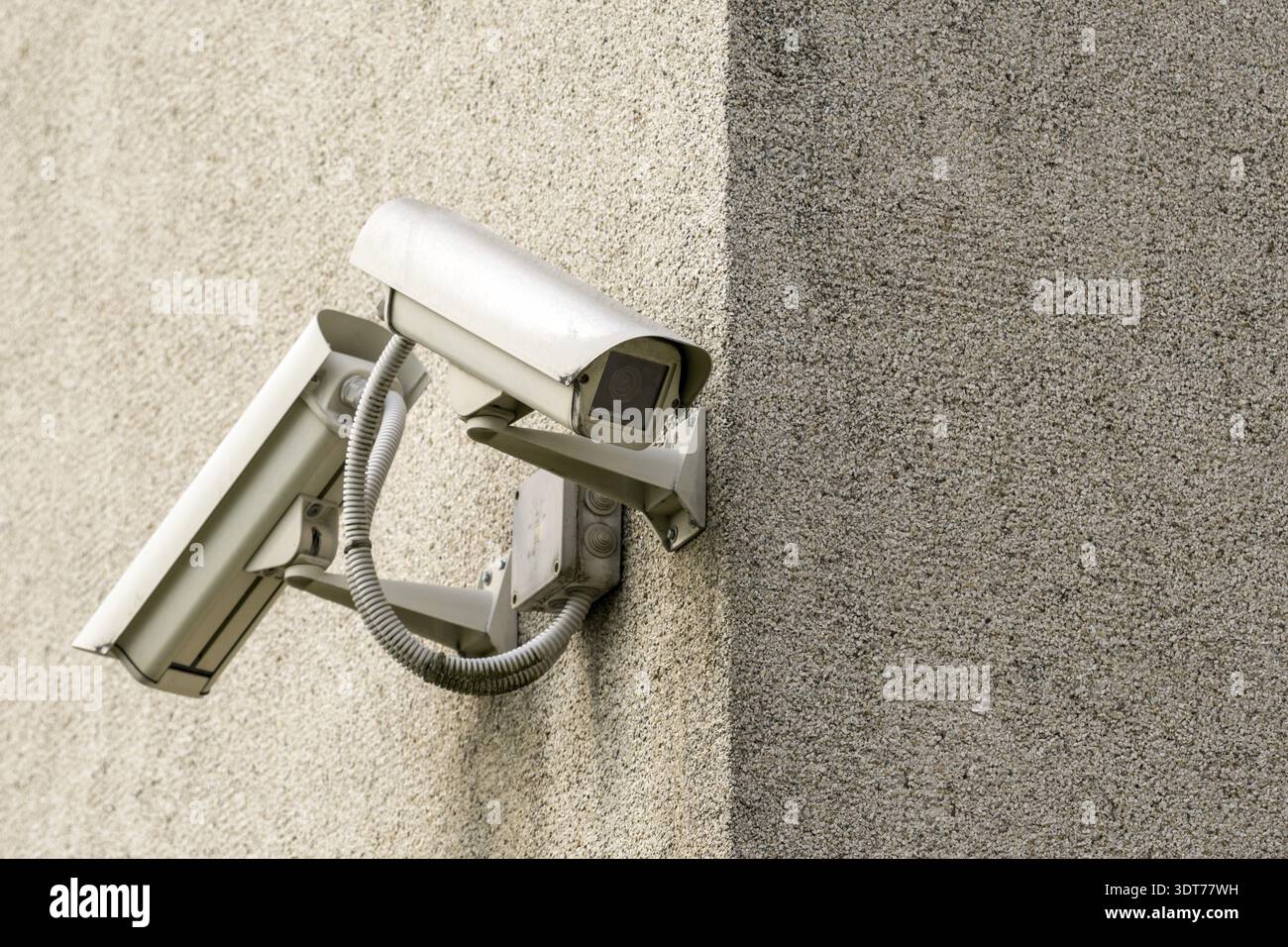 Two CCTV cameras on grey concrete wall. CCTV security system Stock Photo