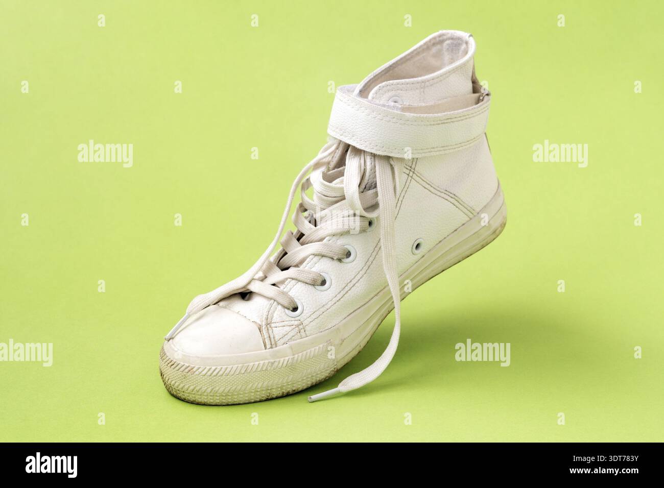 White leather shoe on the green background Stock Photo