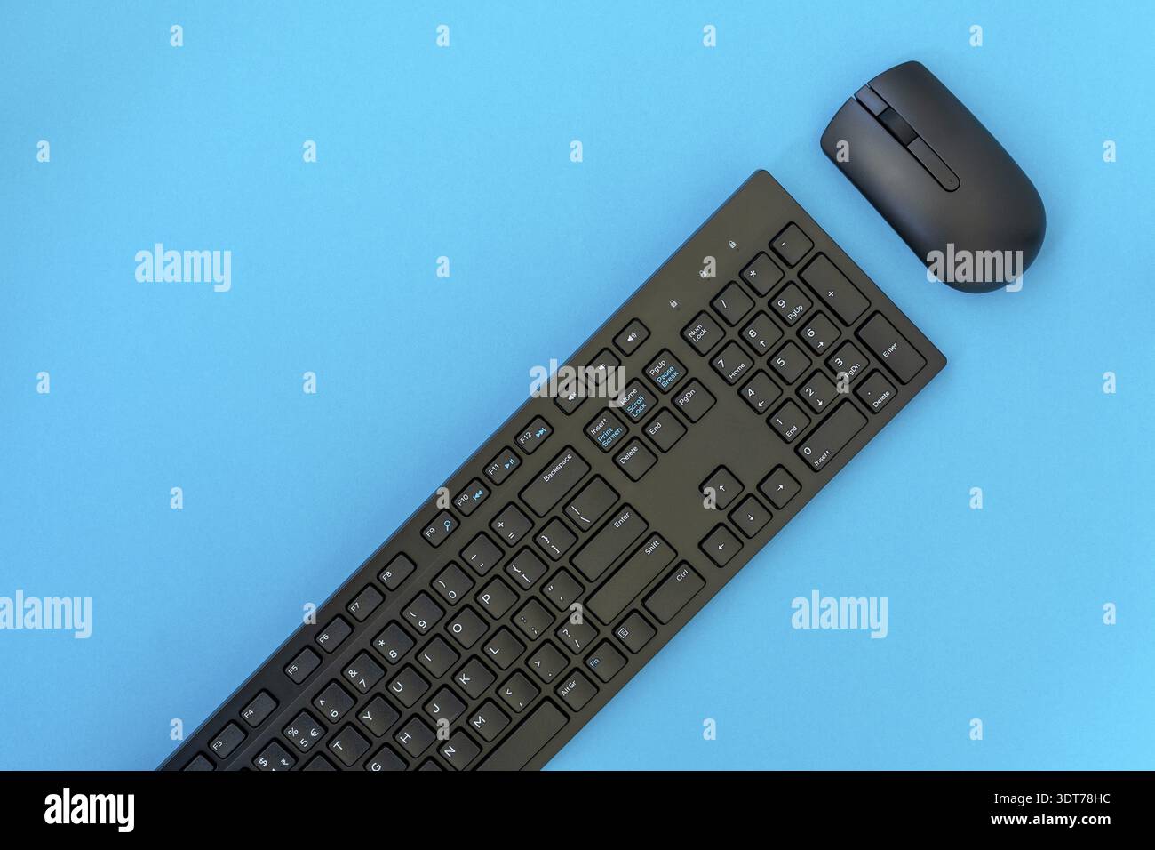 Wireless computer keyboard and mouse on the blue background Stock Photo