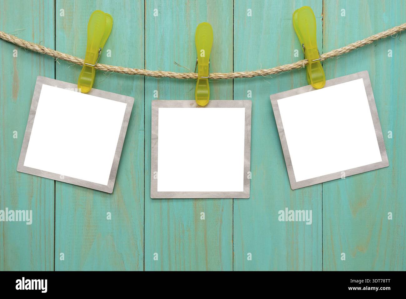 Empty picture frames hanging on rope Stock Photo