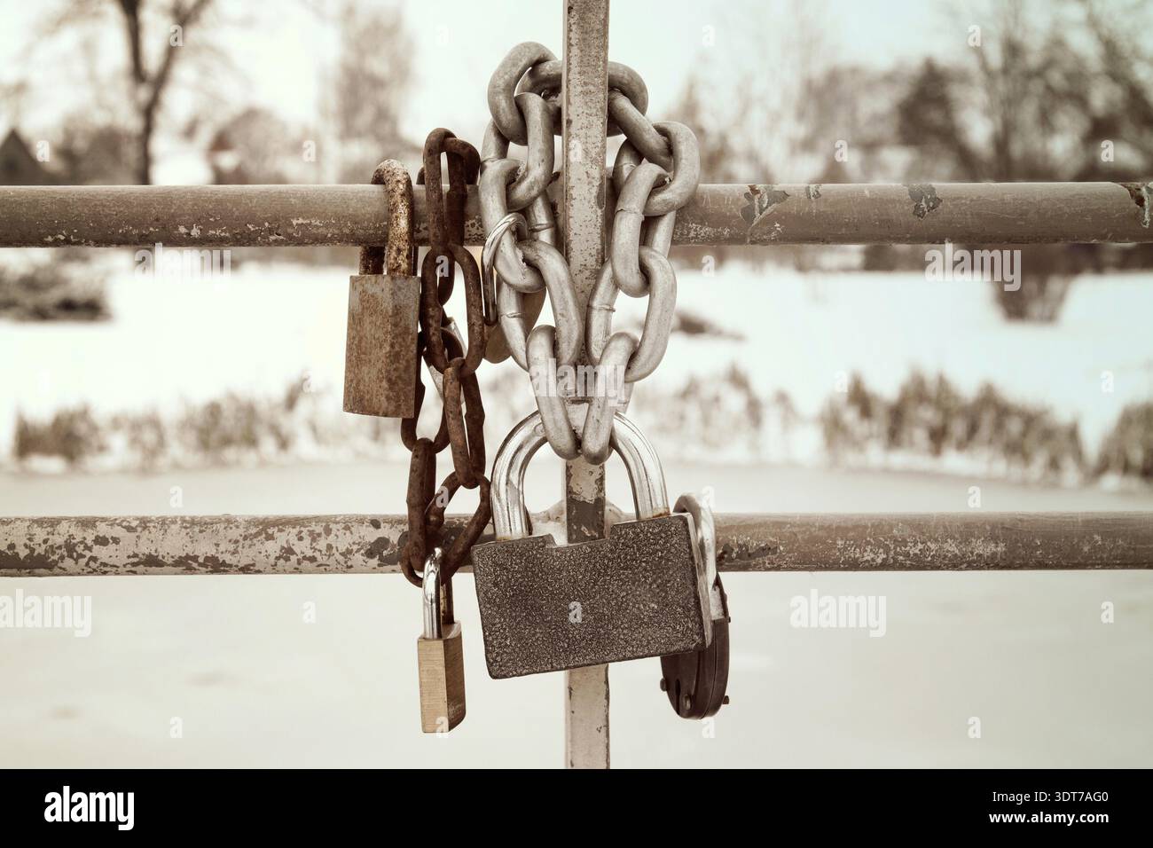 Old rusty padlocks hanging on metal chain Stock Photo