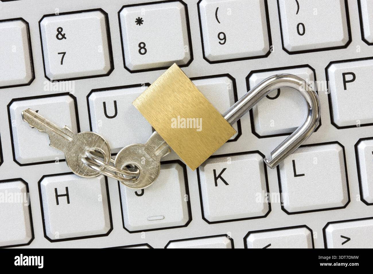 Unlocked padlock with a keys on the computer keyboard Stock Photo