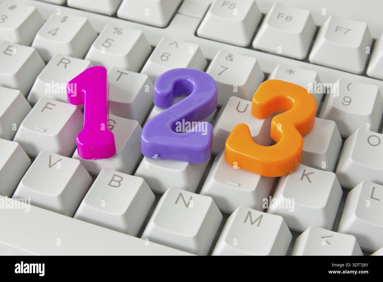 Three color plastic numbers on the computer keyboard Stock Photo