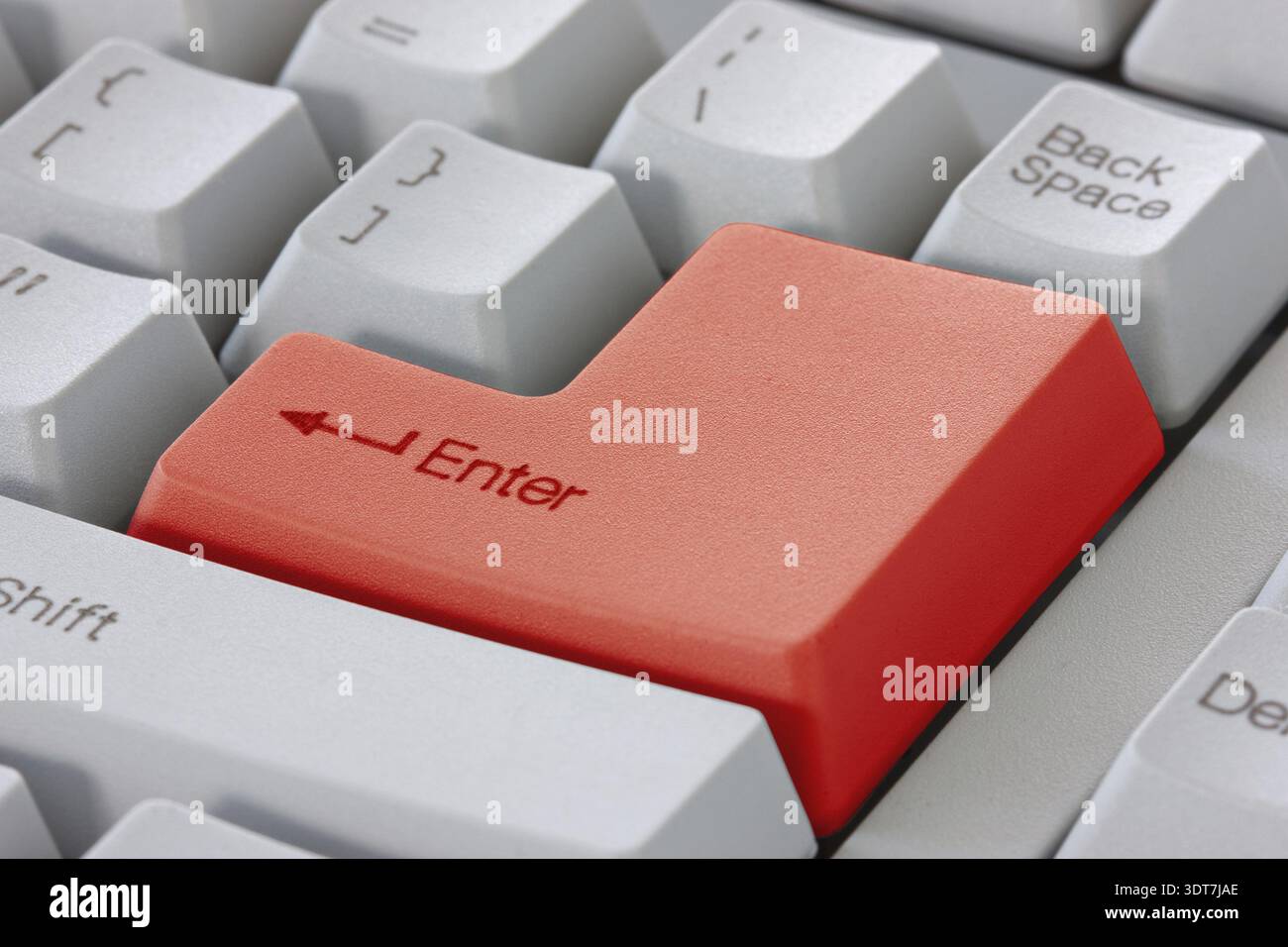 Red enter button on the computer keyboard Stock Photo