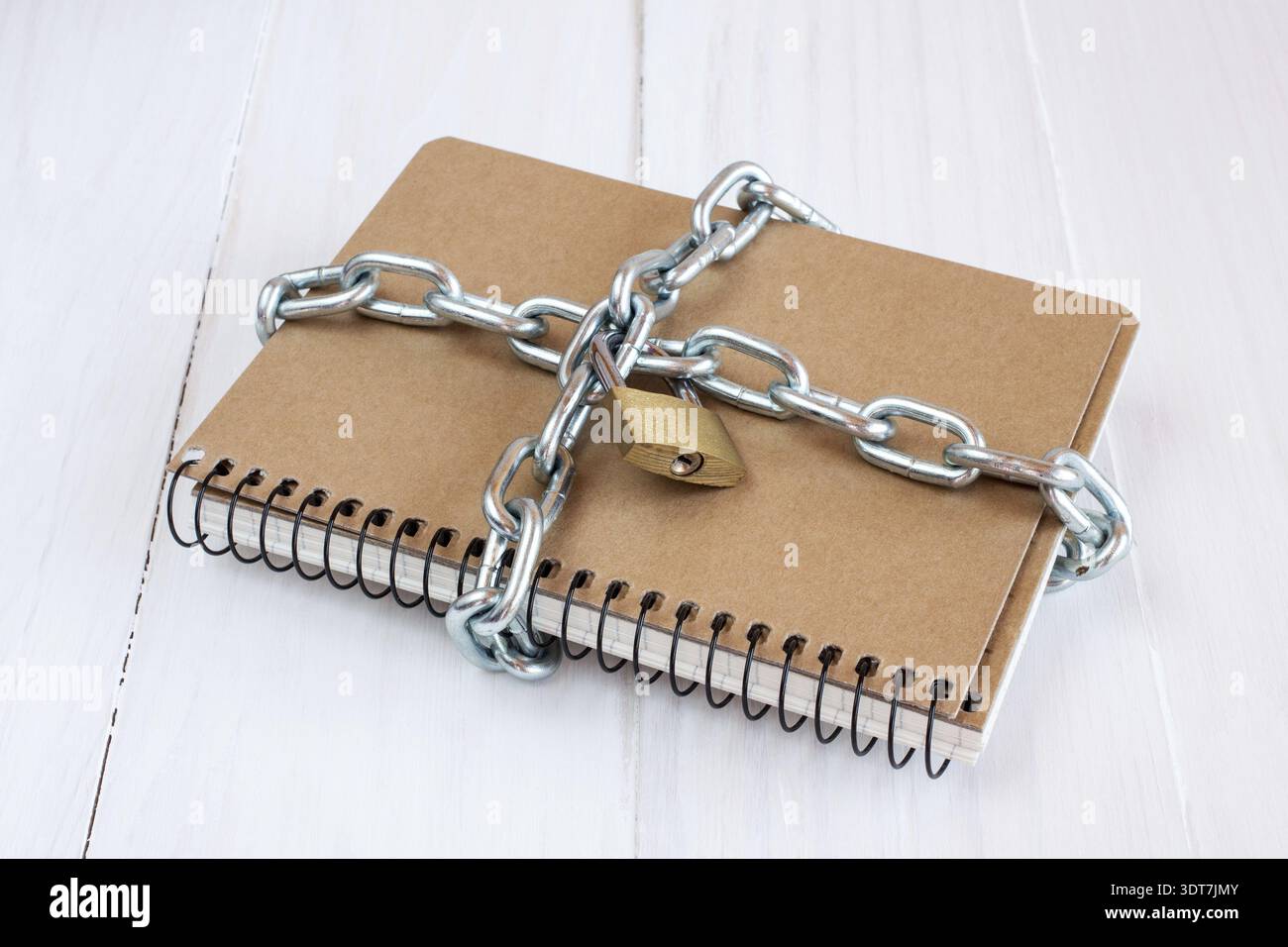 Padlock protects the notepad in a concept on protect the secret information Stock Photo