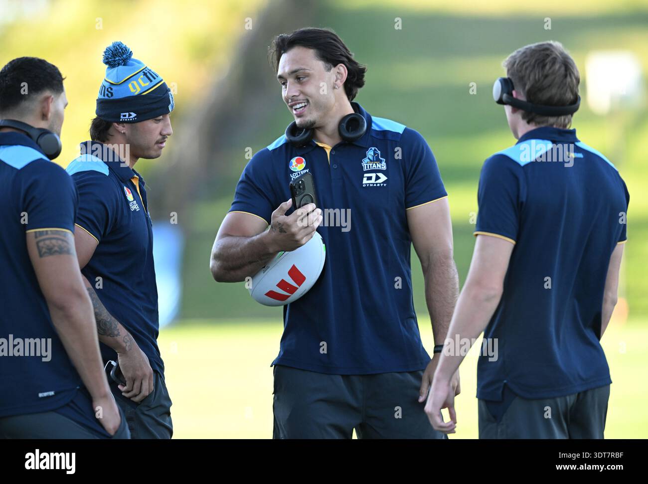 Tino Fa'asuamaleaui (centre) of the Titans is seen with team mates