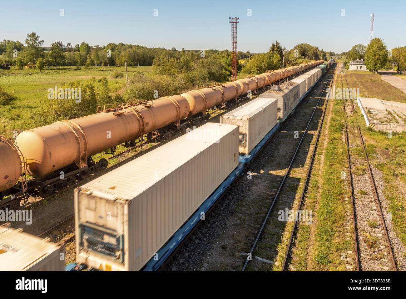 Cargo train platform with white freight containers on the train Stock Photo