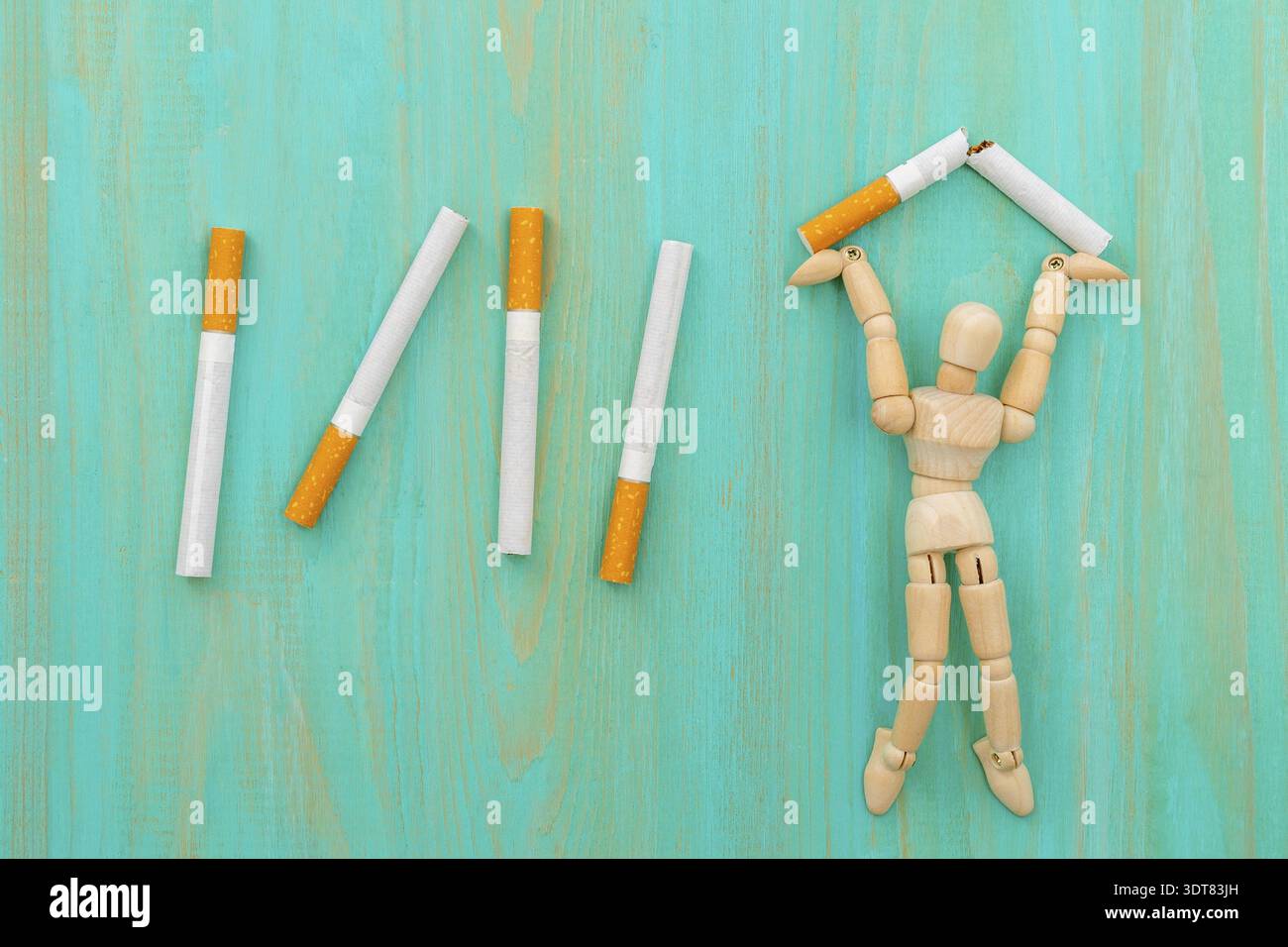 wooden cigarette to quit smoking Quitting smoking - wooden man crushing cigarette. Stop smoking concept  Stock Photo