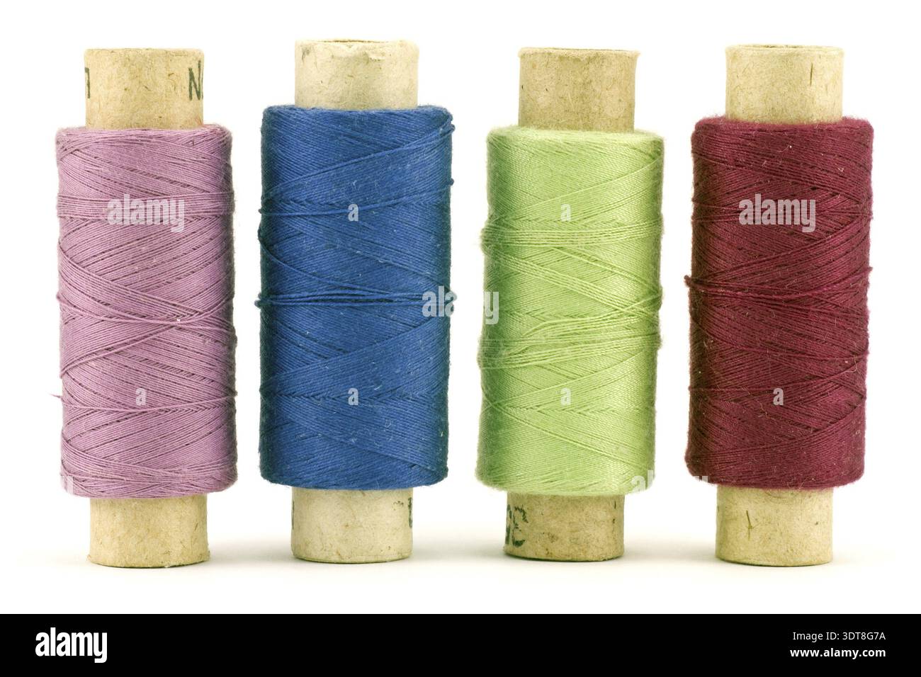 Four colorful thread spools, isolated on white background Stock Photo