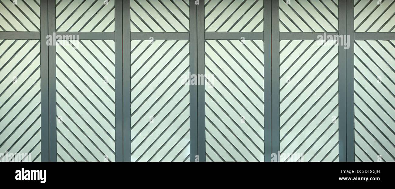 Gray architectural fence pattern forming a background with repeating diagonal lines Stock Photo