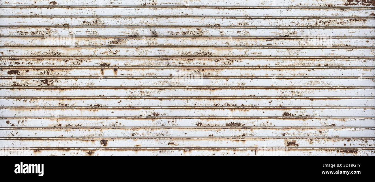 Rusty rolling metal shutter creating an old textured background Stock Photo