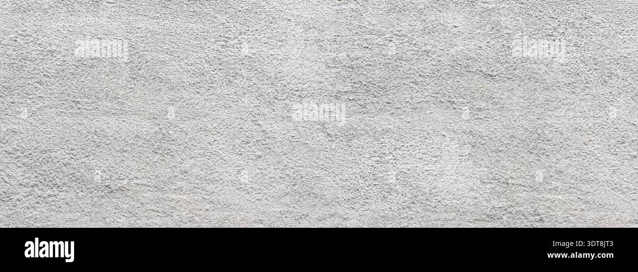 Rough white stucco wall surface creating a grainy exterior texture Stock Photo