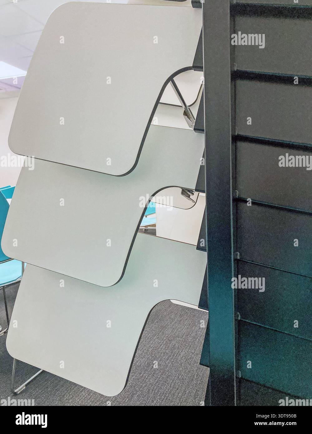 Close-up of removable, desk-tops, designed to fix to chairs, in a storage rack, in a University lecture Room. - Smartphone Captured Stock Image