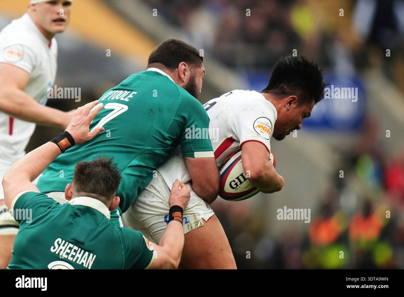 England's Marcus Smith, right, is tackled by Ireland's Tom O'Toole and ...