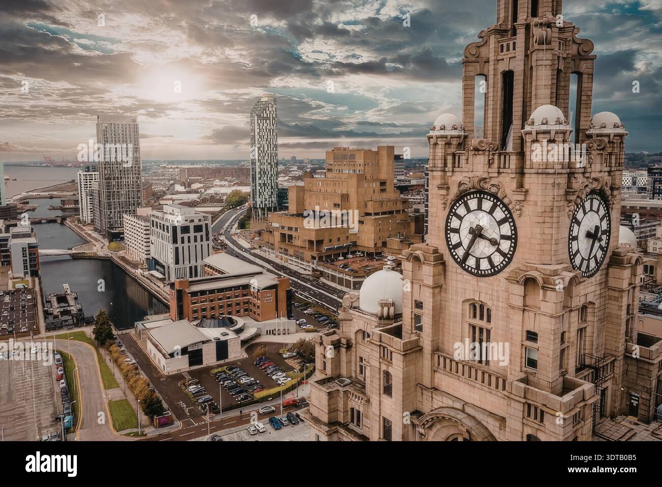 The Liver Building clock tower stands tall against a vibrant sunset ...