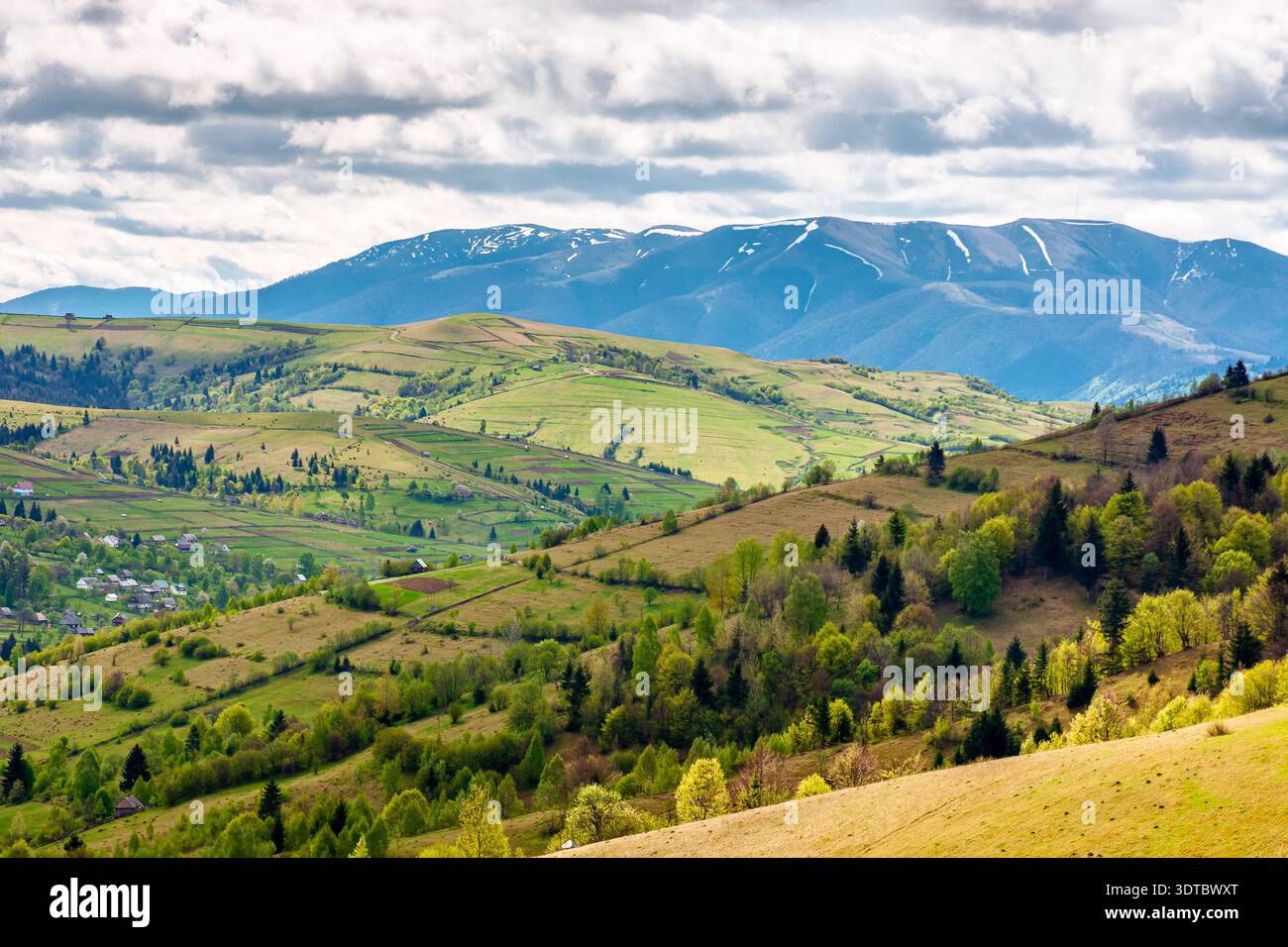 carpathian rural landscape of ukraine in spring. rolling countryside scenery with wooded hills. lovely view to the valley. high mountain range in the Stock Photo