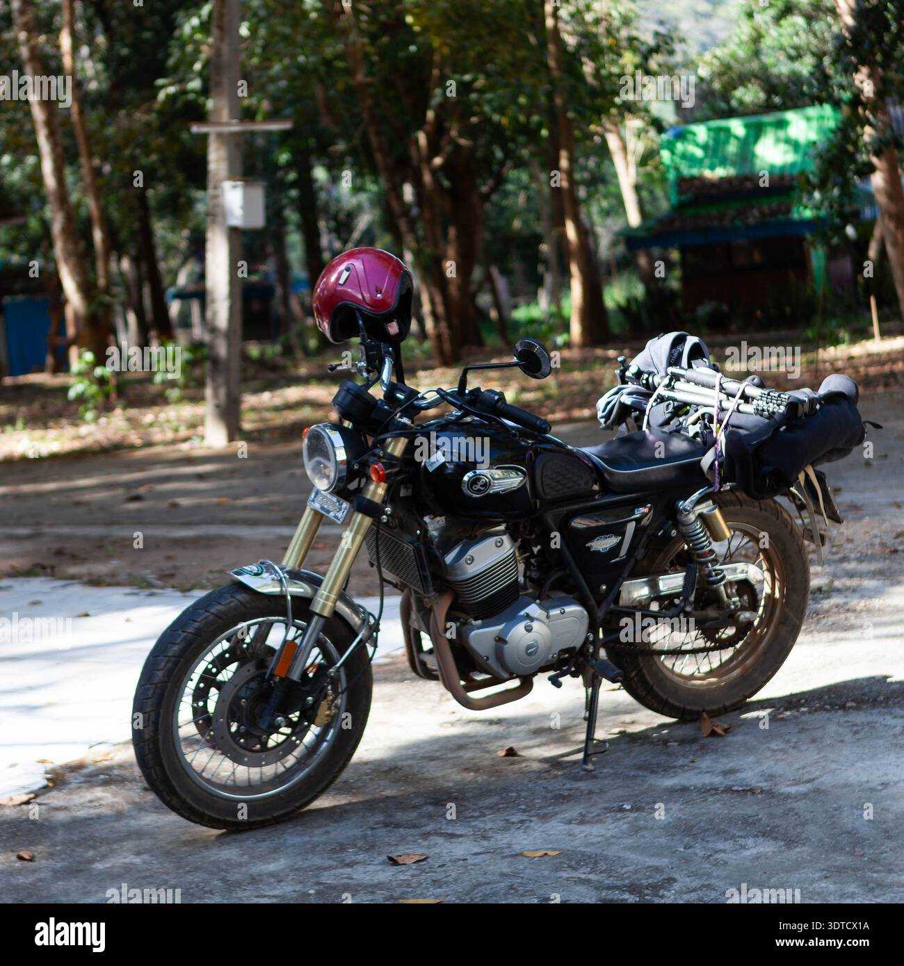 A GPX Legend 250 Twin motorcycle, equipped with a red helmet and 