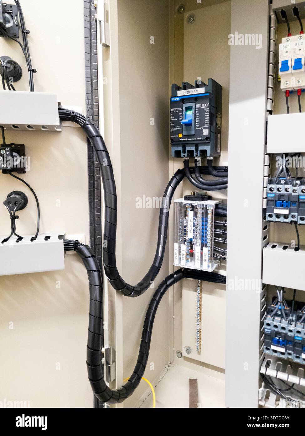 Industrial electrical control panel with wiring and circuit breakers Stock Photo