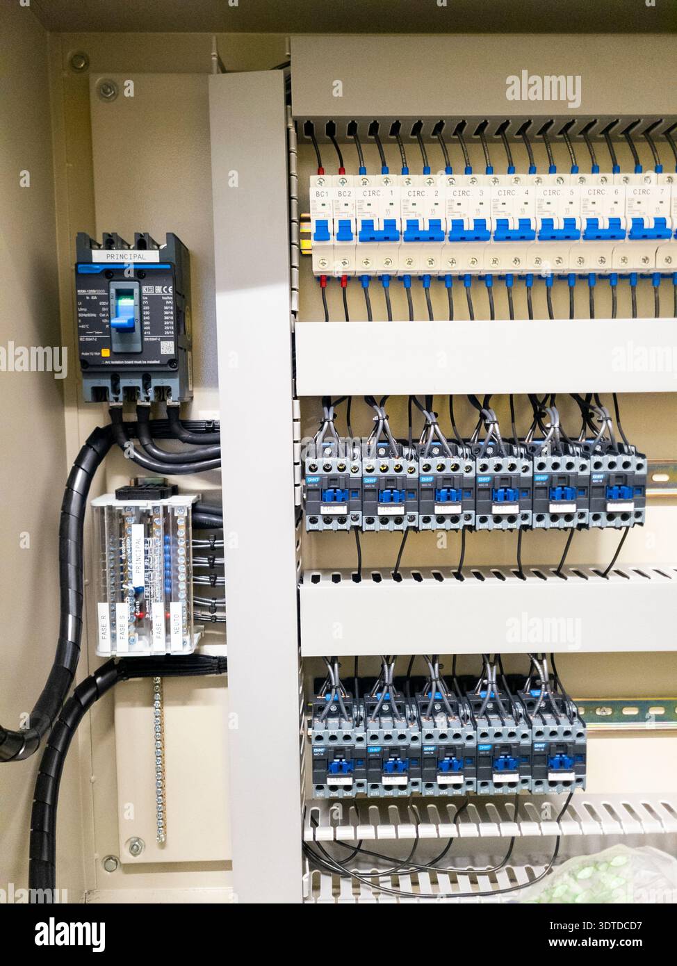 Industrial electrical control panel with wiring and circuit breakers Stock Photo