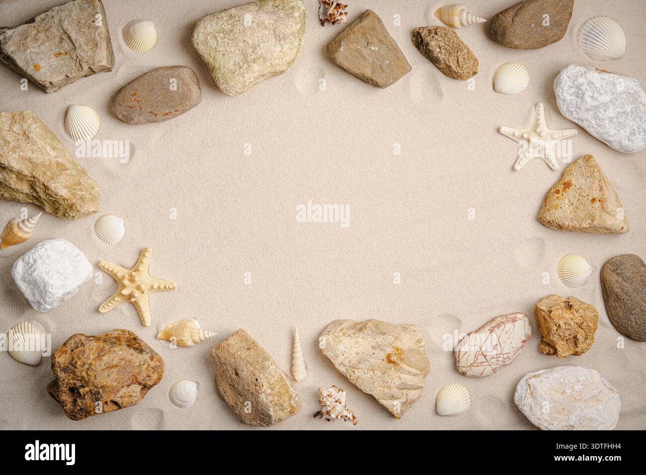 Sandy beach with starfish, seashells and stones for background. Top view. Natural sand stone texture background. Wavy sand background for summer designs. Stock Photo
