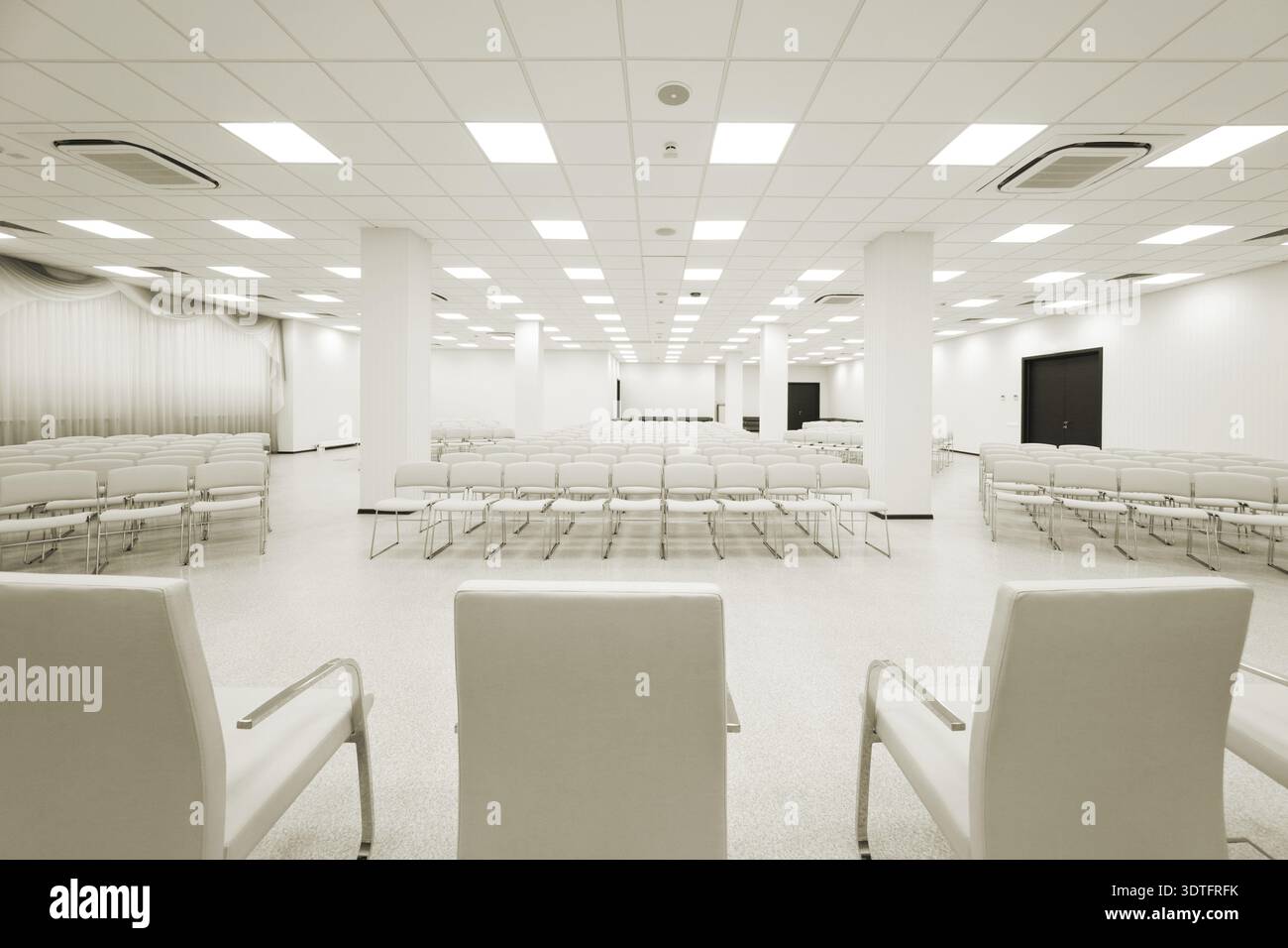 Large and modern white auditorium with curtains Stock Photo