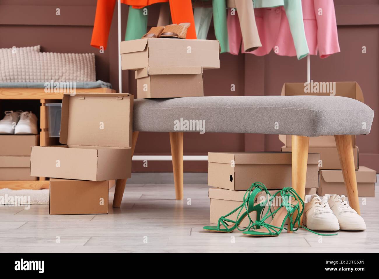 Soft bench with shoe boxes in dressing room Stock Photo