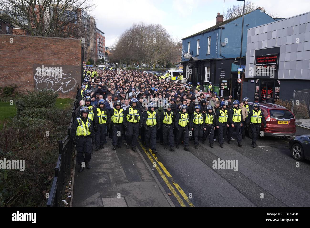 Police officers escort Sheffield Wednesday fans to the ground ahead of ...