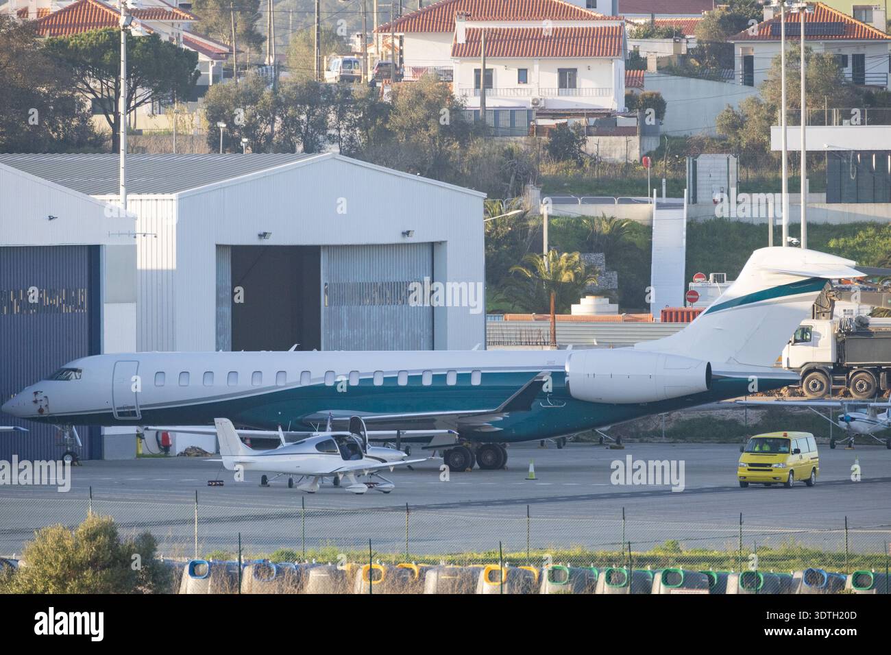 Private business jet and small plane parked at airport hangar Stock ...