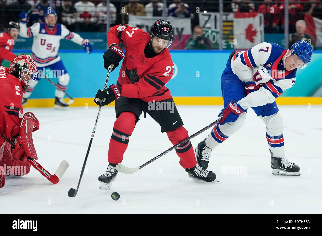 United States' Brady Tkachuk (7) and Canada's Shea Theodore (27) battle ...