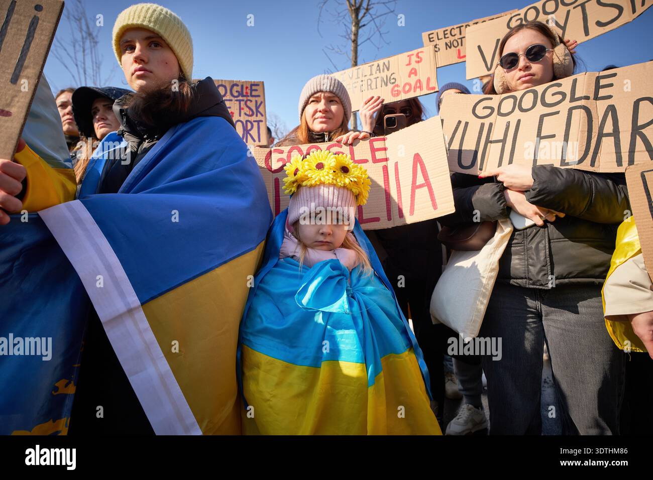 People hold banners as members of the Ukrainian community stage a ...